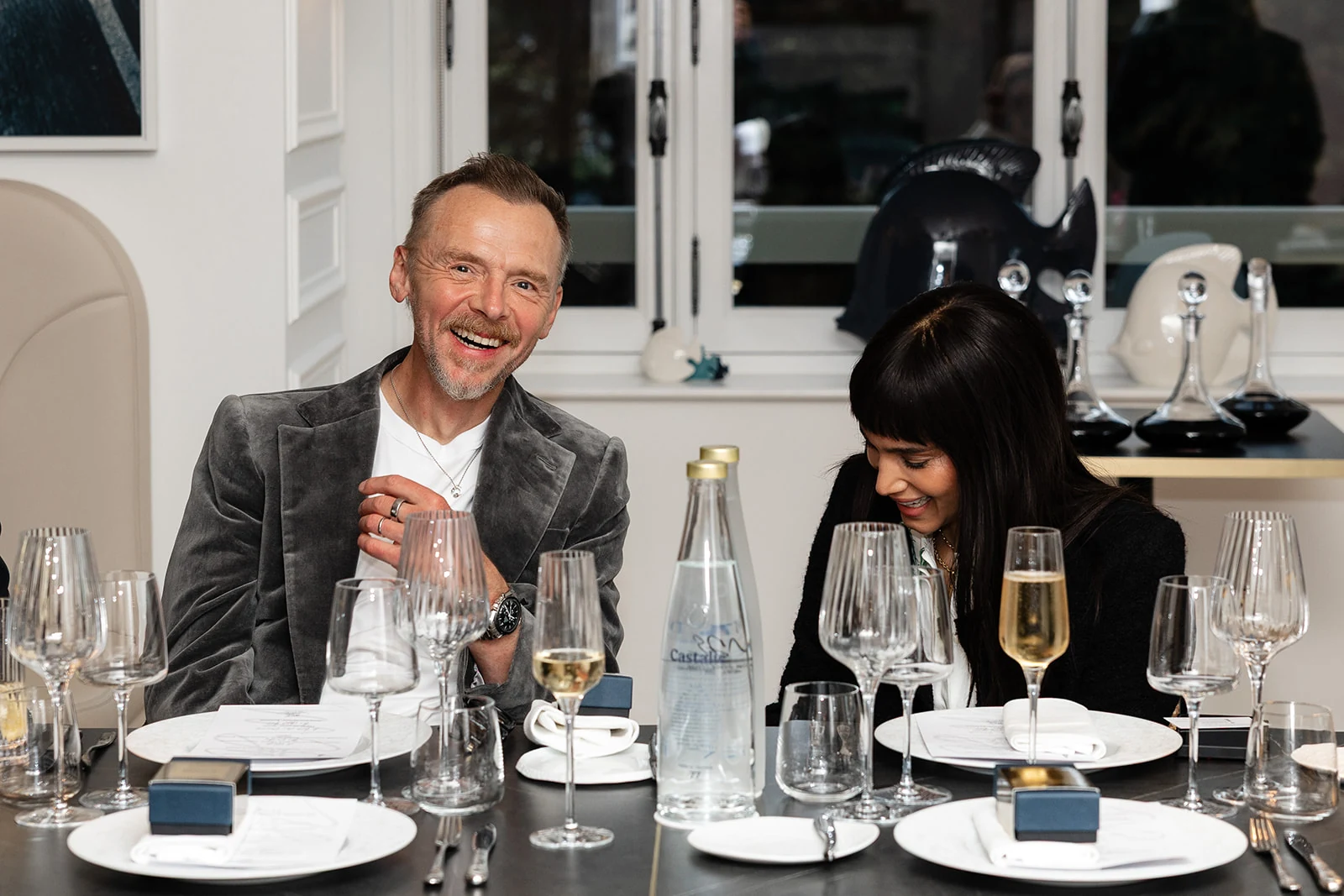 Two guests talk over dinner in a restaurant